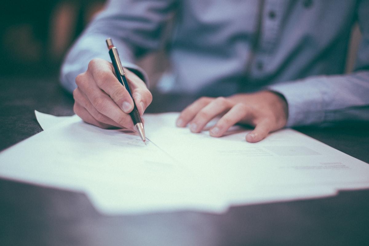Tenant reviewing a tenancy agreement at a kitchen table